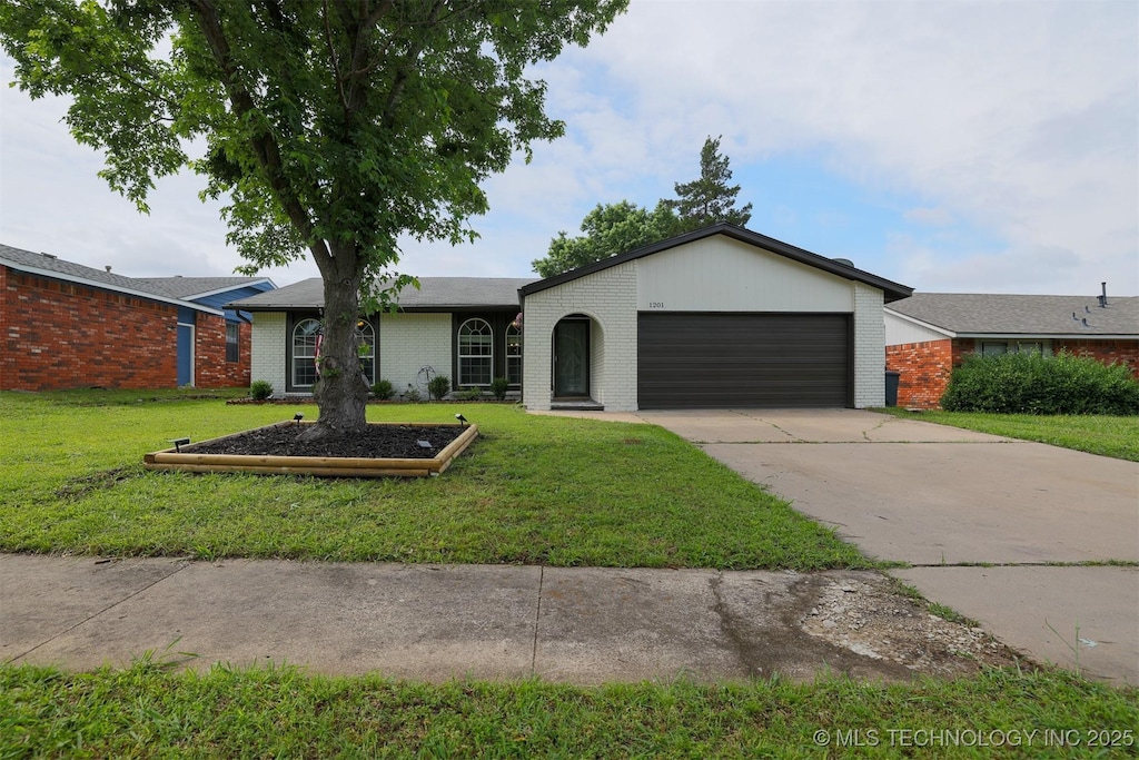 1201 W Jackson St, Broken Arrow, OK 74012 - ranch-style home featuring brick siding, a garage, a front yard, and driveway