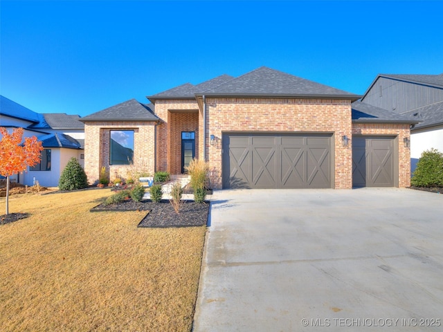 11220 S Fir Ave W, Jenks, OK 74037 - view of front facade with an attached garage, brick siding, concrete driveway, and a front yard