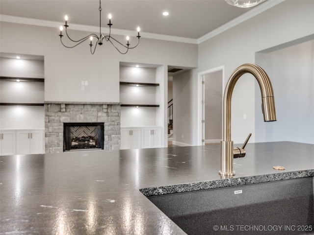 11220 S Fir Ave W, Jenks, OK 74037 - unfurnished living room with built in features, ornamental molding, a fireplace, stairs, and a sink