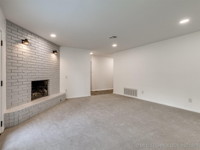 703 NE 8th St, Wagoner, OK 74467 - unfurnished living room with a brick fireplace, carpet floors, recessed lighting, and baseboards