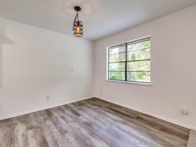 703 NE 8th St, Wagoner, OK 74467 - empty room featuring wood finished floors and baseboards