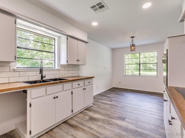 703 NE 8th St, Wagoner, OK 74467 - kitchen with a sink, healthy amount of natural light, backsplash, and recessed lighting