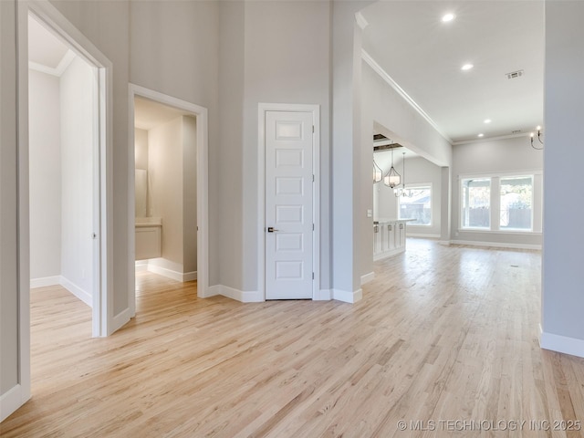 4011 W Baton Rouge St, Broken Arrow, OK 74011 - hallway featuring a chandelier, crown molding, wood finished floors, baseboards, and recessed lighting