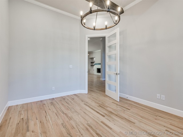 4011 W Baton Rouge St, Broken Arrow, OK 74011 - empty room with a chandelier, ornamental molding, baseboards, wood finished floors, and french doors