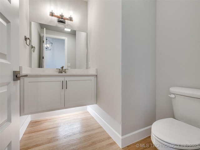 4011 W Baton Rouge St, Broken Arrow, OK 74011 - bathroom with toilet, wood finished floors, vanity, and baseboards