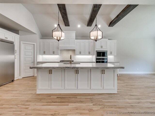 4011 W Baton Rouge St, Broken Arrow, OK 74011 - kitchen with built in appliances, a sink, white cabinetry, backsplash, and a center island with sink