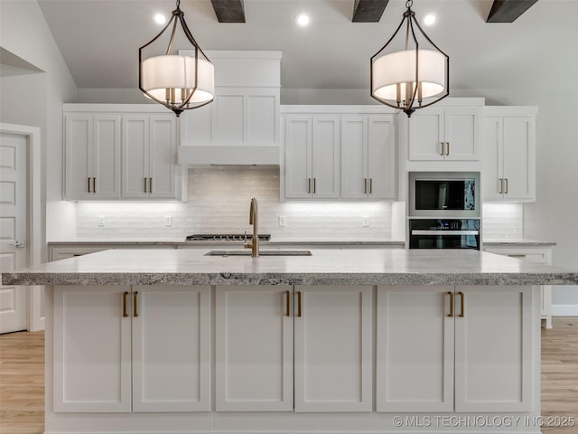 4011 W Baton Rouge St, Broken Arrow, OK 74011 - kitchen with oven, stainless steel microwave, a sink, white cabinets, and backsplash