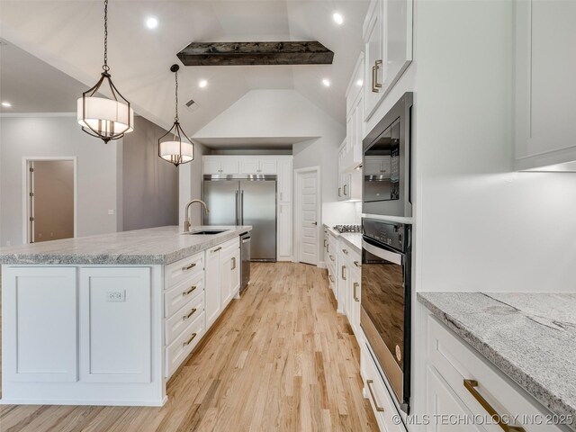 4011 W Baton Rouge St, Broken Arrow, OK 74011 - kitchen with built in appliances, a sink, light wood-style floors, white cabinetry, and recessed lighting