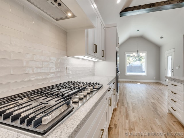 4011 W Baton Rouge St, Broken Arrow, OK 74011 - kitchen with stainless steel gas cooktop, white cabinets, light stone counters, light wood-type flooring, and vaulted ceiling