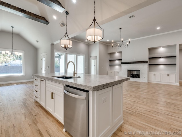 4011 W Baton Rouge St, Broken Arrow, OK 74011 - kitchen with stainless steel dishwasher, a sink, a chandelier, light wood-style floors, and vaulted ceiling