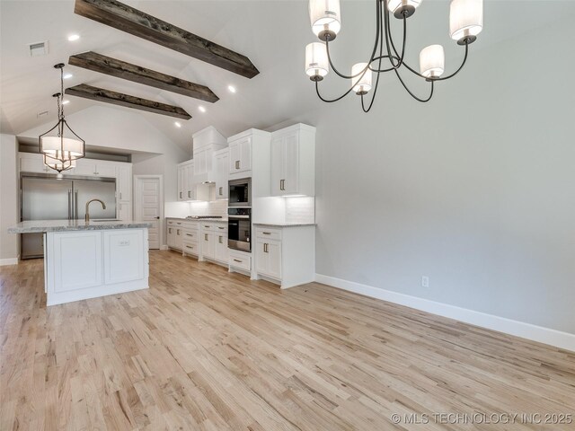 4011 W Baton Rouge St, Broken Arrow, OK 74011 - kitchen featuring built in appliances, a sink, baseboards, and a chandelier