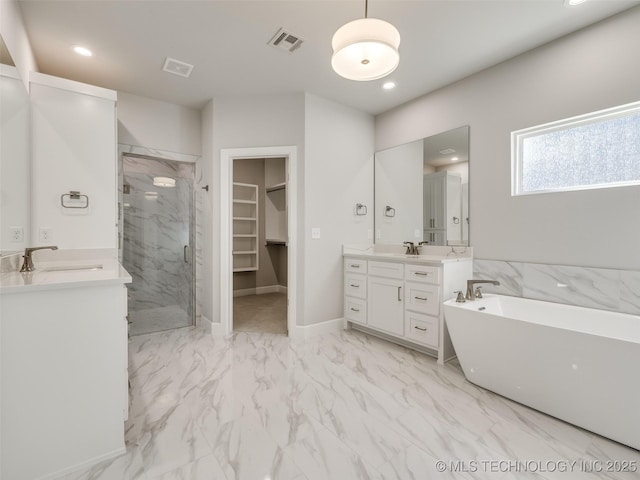 4011 W Baton Rouge St, Broken Arrow, OK 74011 - bathroom featuring marble finish floors, a marble finish shower, two vanities, a freestanding bath, and a walk in closet
