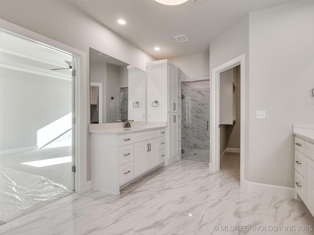4011 W Baton Rouge St, Broken Arrow, OK 74011 - bathroom featuring vanity, marble look tile flooring, a marble finish shower, recessed lighting, and baseboards