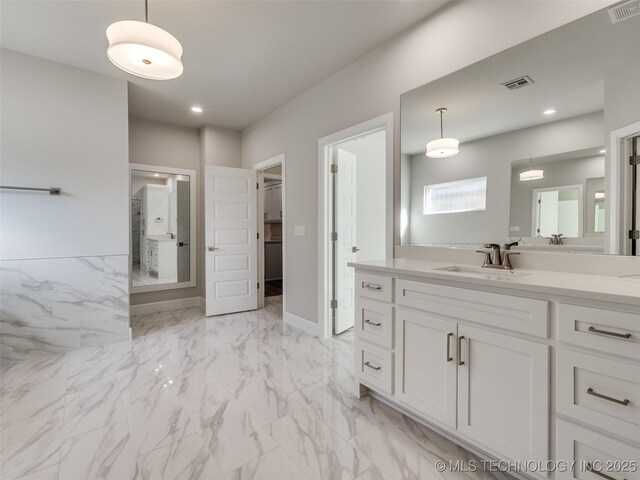4011 W Baton Rouge St, Broken Arrow, OK 74011 - bathroom with vanity, marble finish flooring, recessed lighting, a walk in closet, and baseboards