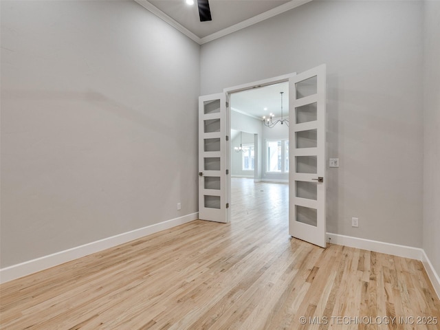 4011 W Baton Rouge St, Broken Arrow, OK 74011 - empty room with crown molding, a chandelier, baseboards, french doors, and wood finished floors