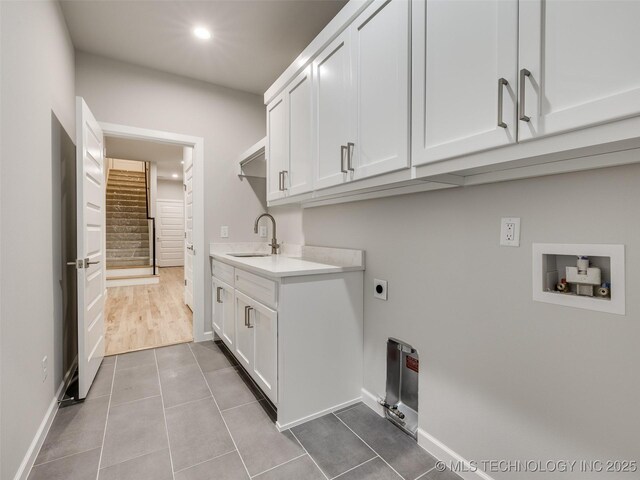4011 W Baton Rouge St, Broken Arrow, OK 74011 - washroom with cabinet space, electric dryer hookup, dark tile patterned flooring, hookup for a washing machine, and recessed lighting