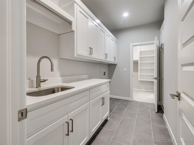 4011 W Baton Rouge St, Broken Arrow, OK 74011 - laundry area featuring cabinet space, washer hookup, baseboards, dark tile patterned flooring, and recessed lighting