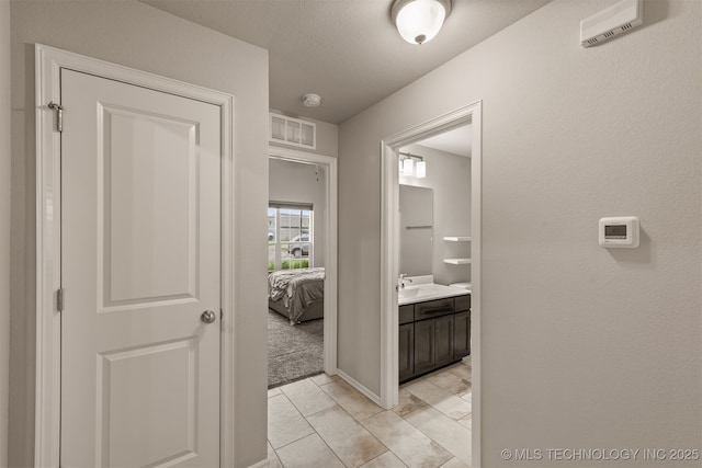 13010 E 122nd Pl, Collinsville, OK 74021 - hall featuring a sink and baseboards