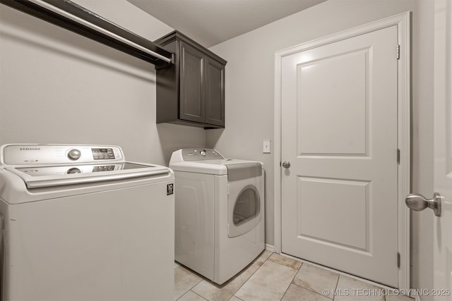 13010 E 122nd Pl, Collinsville, OK 74021 - laundry room featuring washer and clothes dryer, cabinet space, and light tile patterned floors