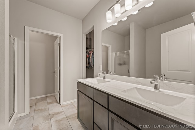 13010 E 122nd Pl, Collinsville, OK 74021 - full bath featuring double vanity, a stall shower, a spacious closet, baseboards, and tile patterned floors