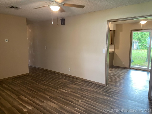 305 N 10th St, Hartshorne, OK 74547 - unfurnished room with ceiling fan, dark wood-style flooring, and a textured ceiling