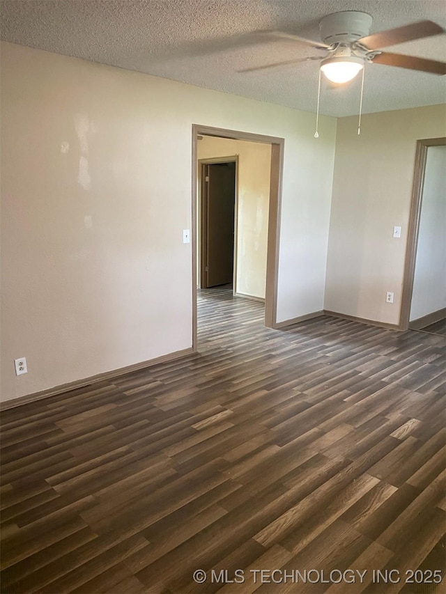 305 N 10th St, Hartshorne, OK 74547 - spare room featuring dark wood-type flooring, ceiling fan, and a textured ceiling