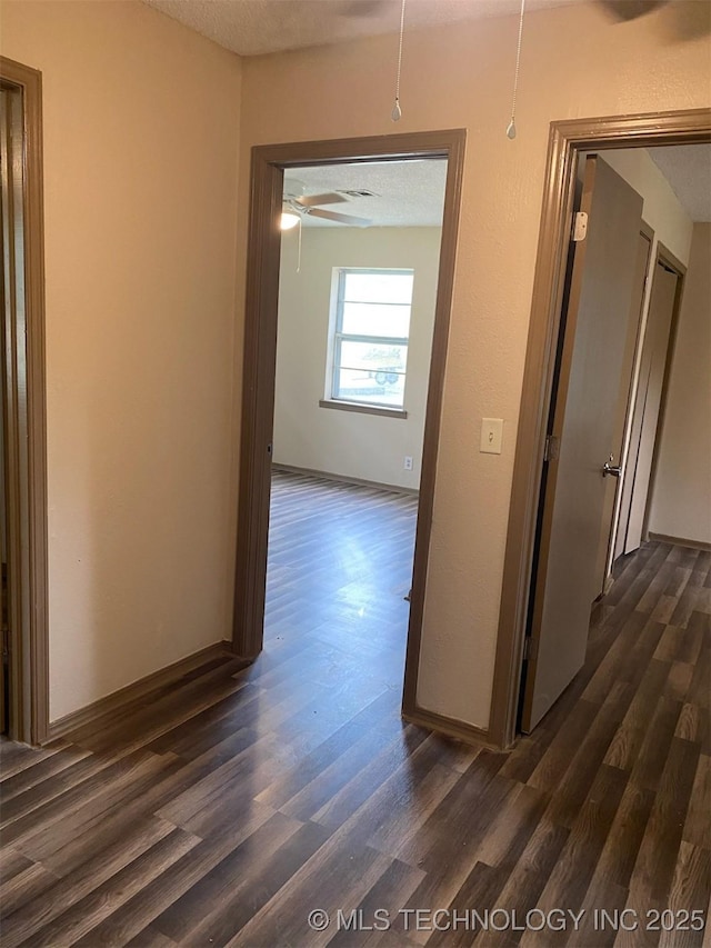 305 N 10th St, Hartshorne, OK 74547 - hall featuring dark wood-style flooring and a textured ceiling