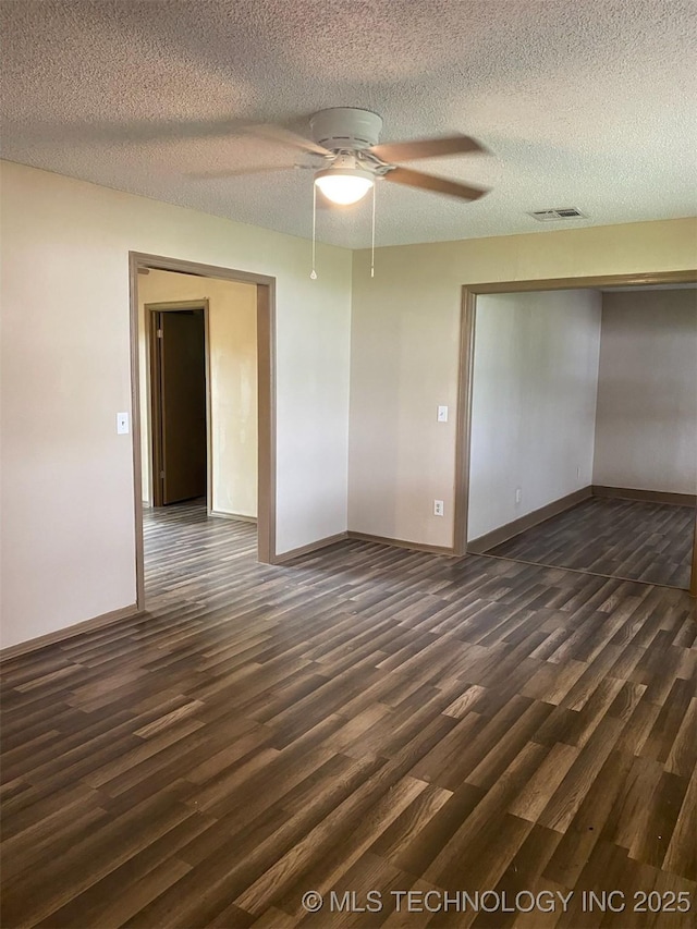 305 N 10th St, Hartshorne, OK 74547 - unfurnished room featuring dark wood finished floors, ceiling fan, and a textured ceiling