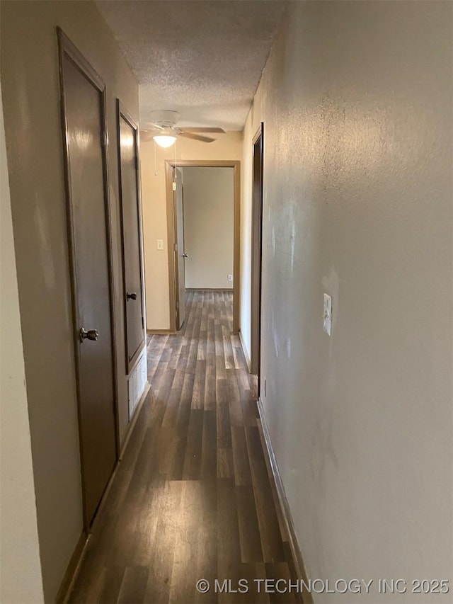 305 N 10th St, Hartshorne, OK 74547 - hallway featuring dark wood finished floors and a textured ceiling