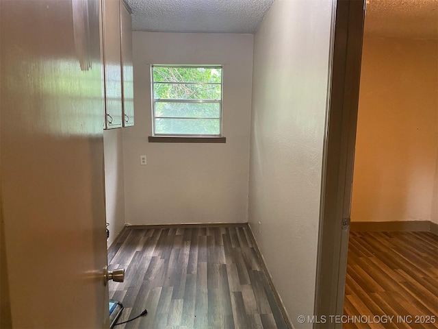 305 N 10th St, Hartshorne, OK 74547 - hall with wood finished floors and a textured ceiling