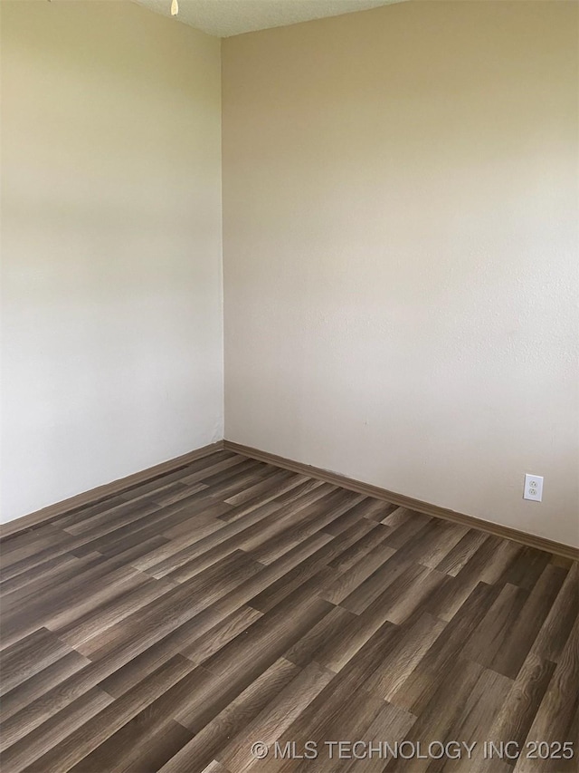 305 N 10th St, Hartshorne, OK 74547 - empty room with dark wood-style flooring