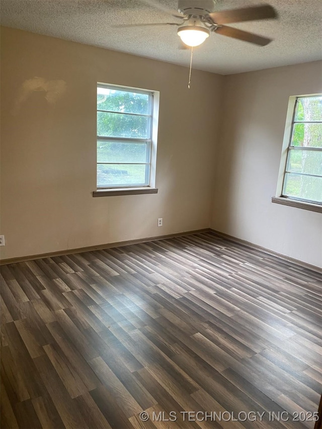 305 N 10th St, Hartshorne, OK 74547 - unfurnished room featuring a ceiling fan, dark wood-type flooring, and a textured ceiling