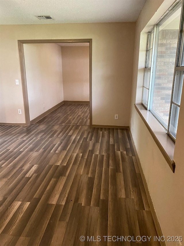 305 N 10th St, Hartshorne, OK 74547 - unfurnished room with wood finished floors and a textured ceiling