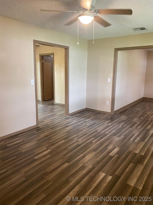 305 N 10th St, Hartshorne, OK 74547 - spare room featuring dark wood-style floors, ceiling fan, and a textured ceiling