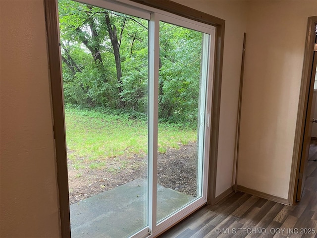 305 N 10th St, Hartshorne, OK 74547 - doorway to outside featuring wood finished floors and baseboards