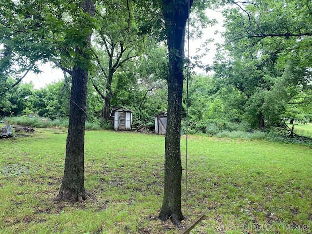 305 N 10th St, Hartshorne, OK 74547 - view of grassy yard with a storage unit