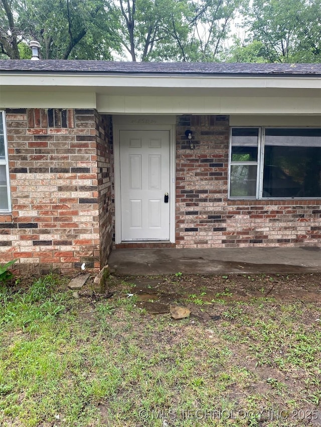 305 N 10th St, Hartshorne, OK 74547 - doorway to property featuring brick siding