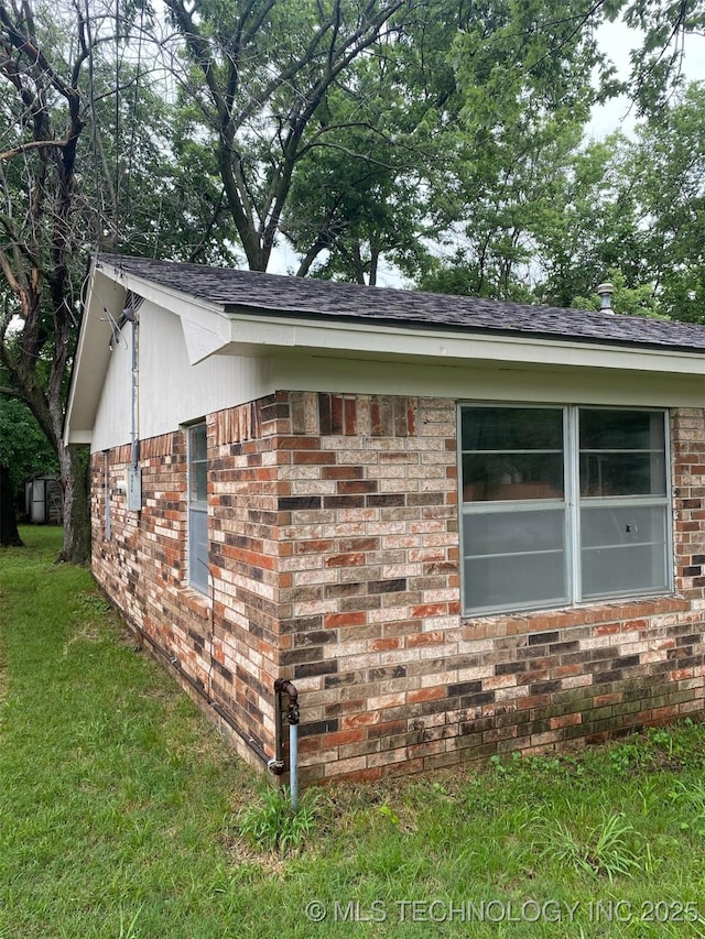 305 N 10th St, Hartshorne, OK 74547 - view of side of property featuring brick siding and a lawn