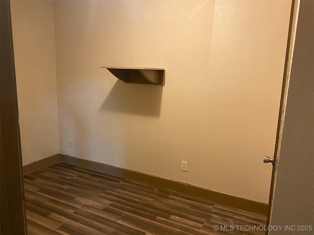 305 N 10th St, Hartshorne, OK 74547 - empty room featuring dark wood-type flooring and baseboards
