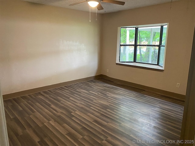 305 N 10th St, Hartshorne, OK 74547 - empty room featuring a ceiling fan, dark wood-type flooring, and a textured ceiling