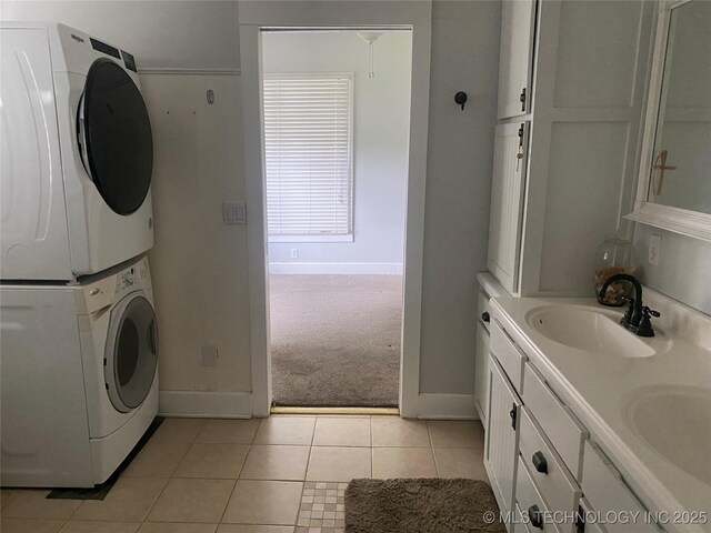 301 E Elm Ave, Eufaula, OK 74432 - washroom featuring stacked washer / drying machine, baseboards, light tile patterned floors, and light carpet