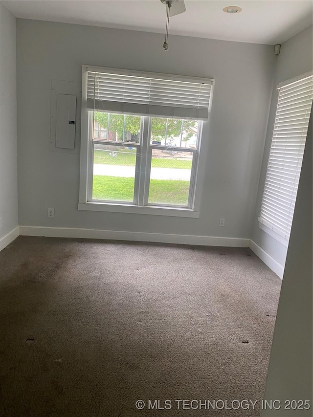 301 E Elm Ave, Eufaula, OK 74432 - carpeted spare room featuring electric panel and baseboards