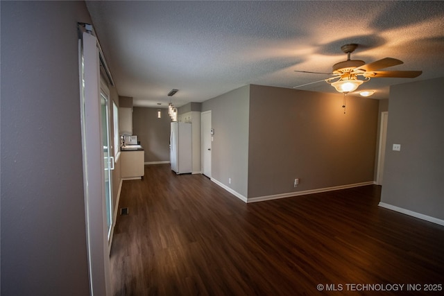 11612 E 28th St, Tulsa, OK 74129 - spare room with dark wood finished floors, ceiling fan, baseboards, and a textured ceiling