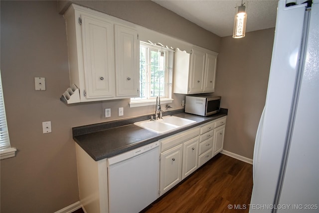 11612 E 28th St, Tulsa, OK 74129 - kitchen featuring white appliances, a sink, dark countertops, dark wood-type flooring, and white cabinets