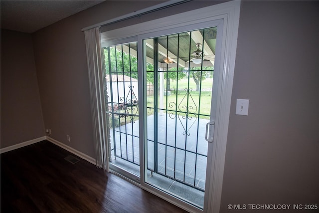 11612 E 28th St, Tulsa, OK 74129 - doorway to outside featuring dark wood finished floors, baseboards, and a ceiling fan