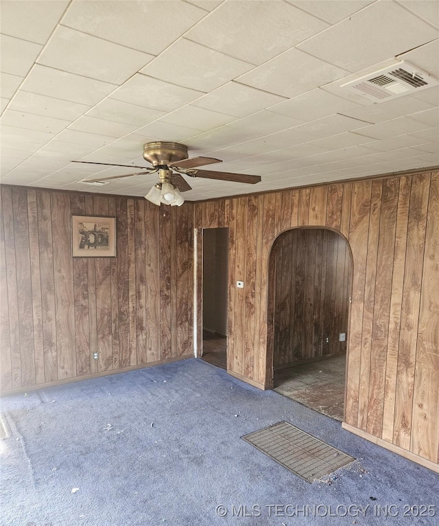 737 W Doolin Ave, Blackwell, OK 74631 - empty room featuring carpet, wood walls, and ceiling fan