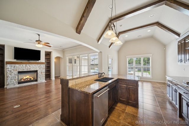 16210 E 49th St, Tulsa, OK 74134 - kitchen featuring stainless steel dishwasher, a sink, dark brown cabinetry, ceiling fan, and arched walkways