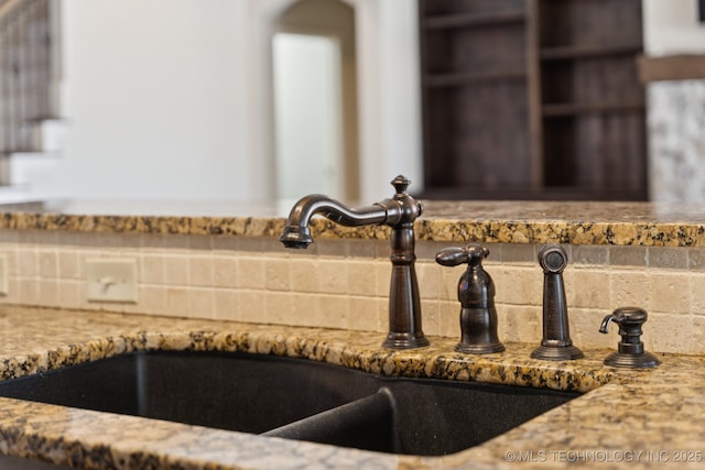 16210 E 49th St, Tulsa, OK 74134 - kitchen view of a sink, light stone counters, and tasteful backsplash
