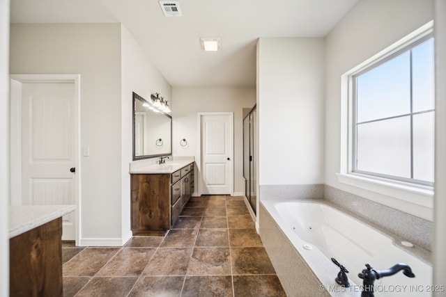 16210 E 49th St, Tulsa, OK 74134 - bathroom with vanity, healthy amount of natural light, a tub with jets, and a shower stall