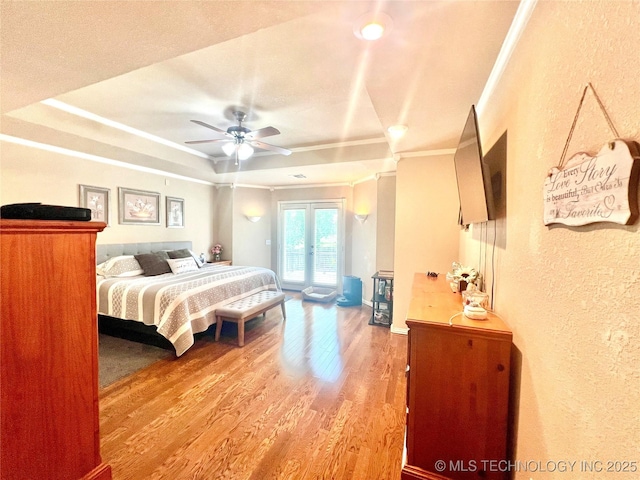 1403 NW Mimosa Cir, Stigler, OK 74462 - bedroom featuring access to exterior, ornamental molding, a textured wall, light wood-style flooring, and a ceiling fan